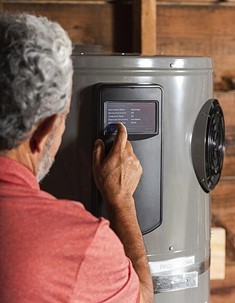 Man checking data on Heat Pump Water Heater